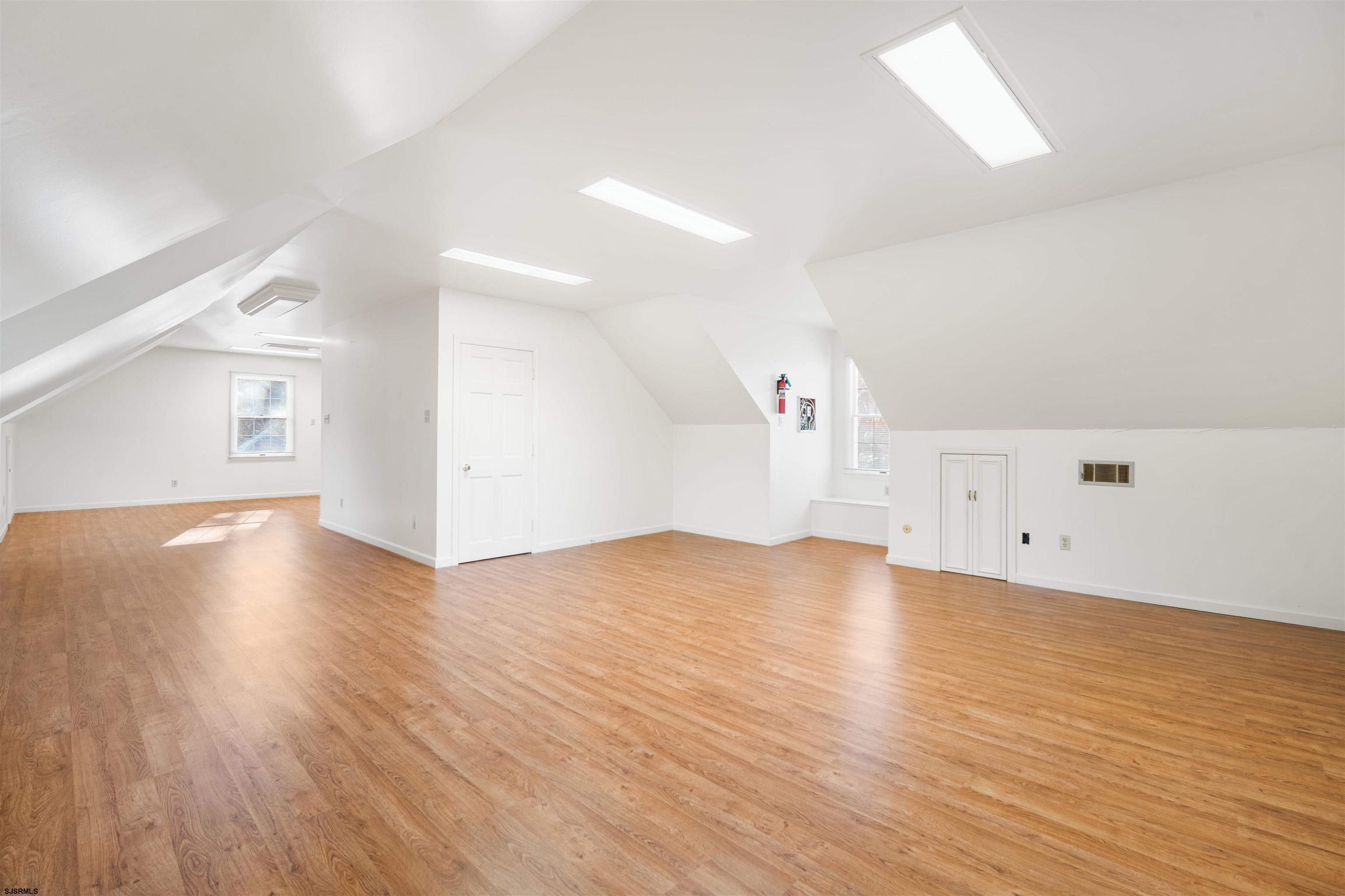 216 Riverside Drive Port Republic, NJ 08241 - Photo 27 of 47 an empty room with wooden floor and windows