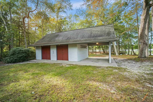 a view of a house with backyard and trees