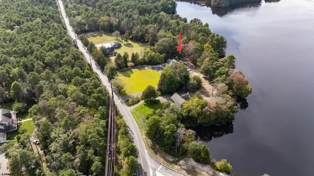 an aerial view of residential houses with outdoor space and river