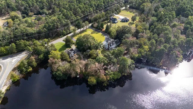 a view of a house with a yard and swimming pool