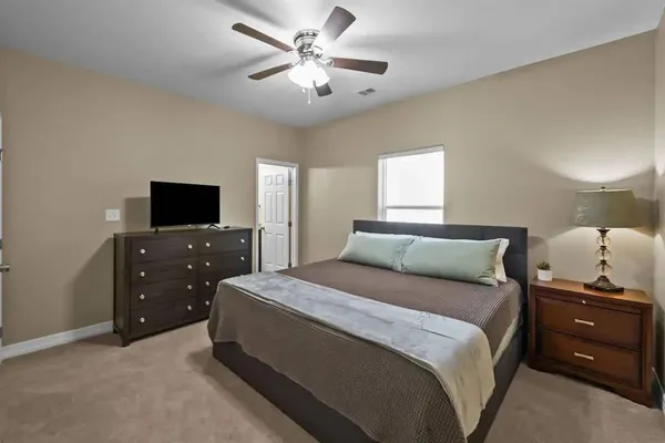 a bedroom with a bed and a tv