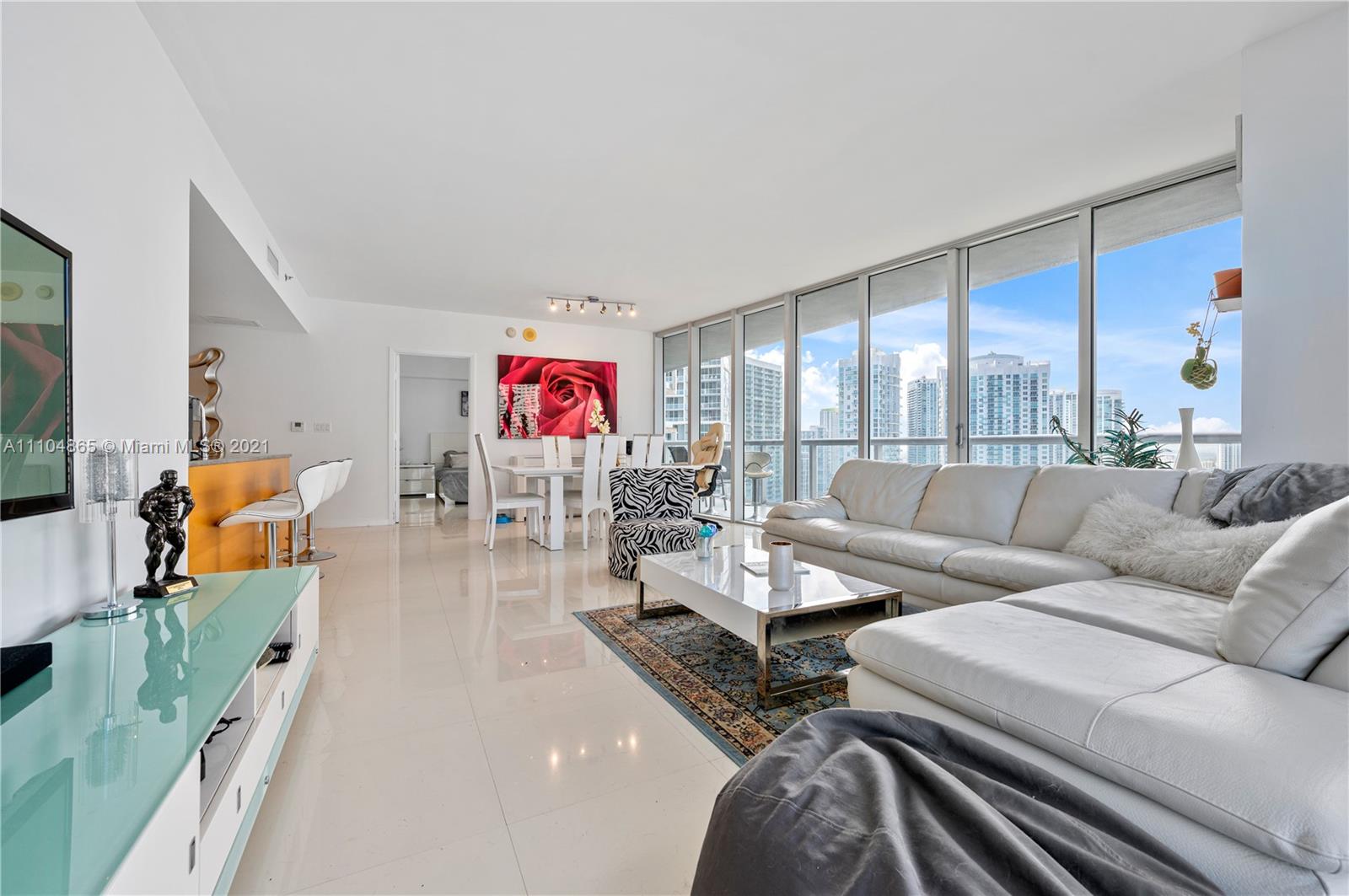 465 Brickell Avenue, Unit 2702 Miami, FL 33131 - Photo 11 of 37 a living room with furniture kitchen view and a large window