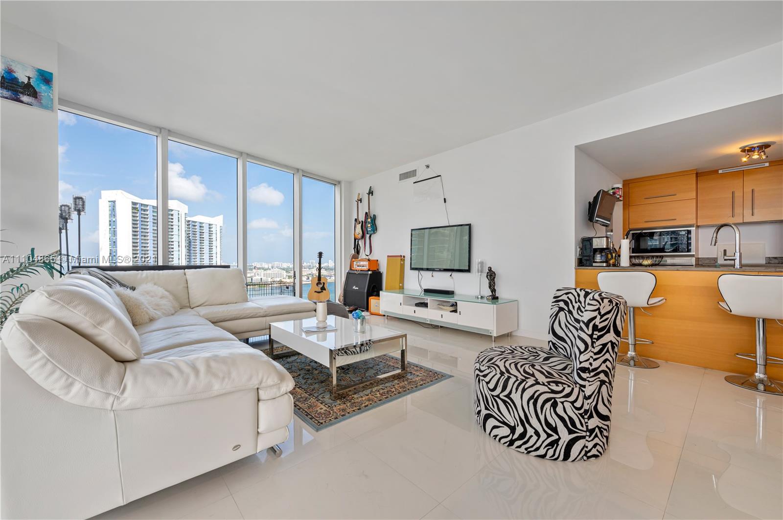 465 Brickell Avenue, Unit 2702 Miami, FL 33131 - Photo 12 of 37 a living room with furniture kitchen view and a large window