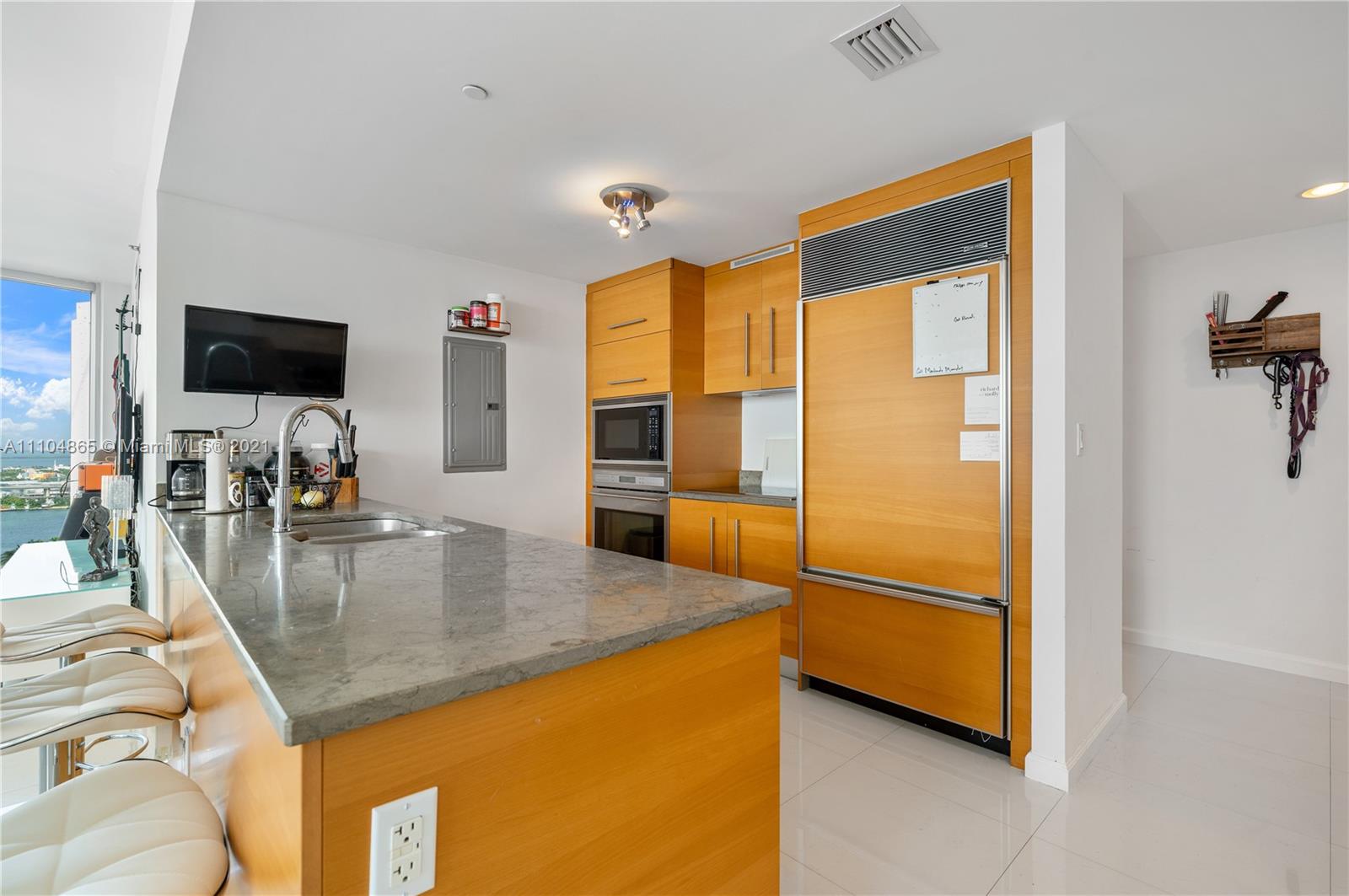 465 Brickell Avenue, Unit 2702 Miami, FL 33131 - Photo 13 of 37 a kitchen with a sink a counter top space and stainless steel appliances