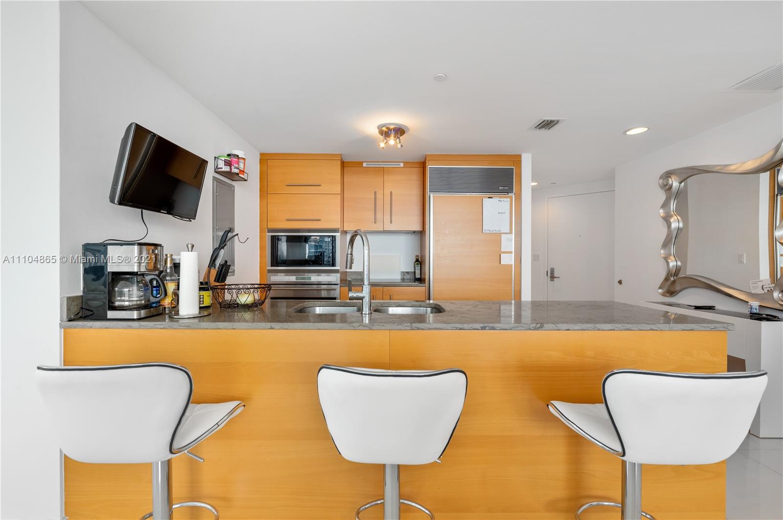 465 Brickell Avenue, Unit 2702 Miami, FL 33131 - Photo 14 of 37 a living room with furniture and a flat screen tv