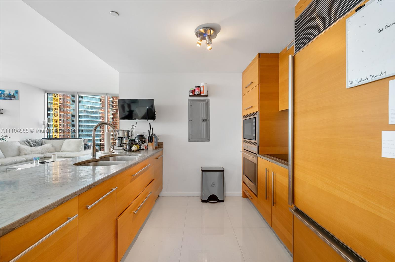 465 Brickell Avenue, Unit 2702 Miami, FL 33131 - Photo 15 of 37 a kitchen with stainless steel appliances granite countertop a sink and cabinets
