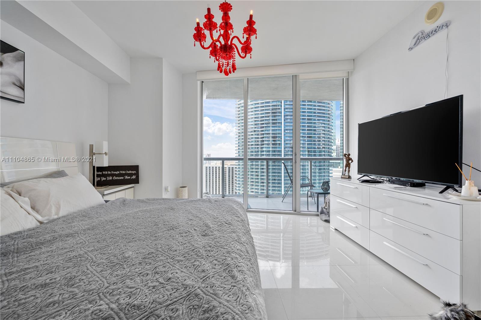 465 Brickell Avenue, Unit 2702 Miami, FL 33131 - Photo 18 of 37 a bedroom with a bed and a flat screen television