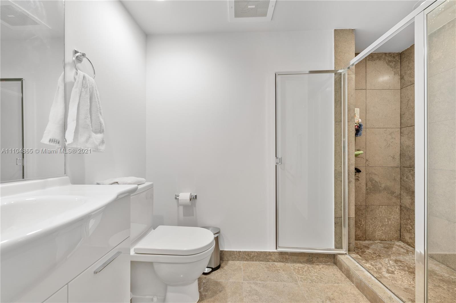 465 Brickell Avenue, Unit 2702 Miami, FL 33131 - Photo 28 of 37 a bathroom with a sink a toilet and shower