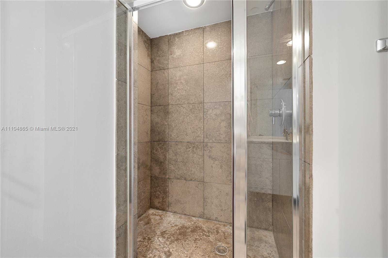 465 Brickell Avenue, Unit 2702 Miami, FL 33131 - Photo 29 of 37 a bathroom with a glass shower door