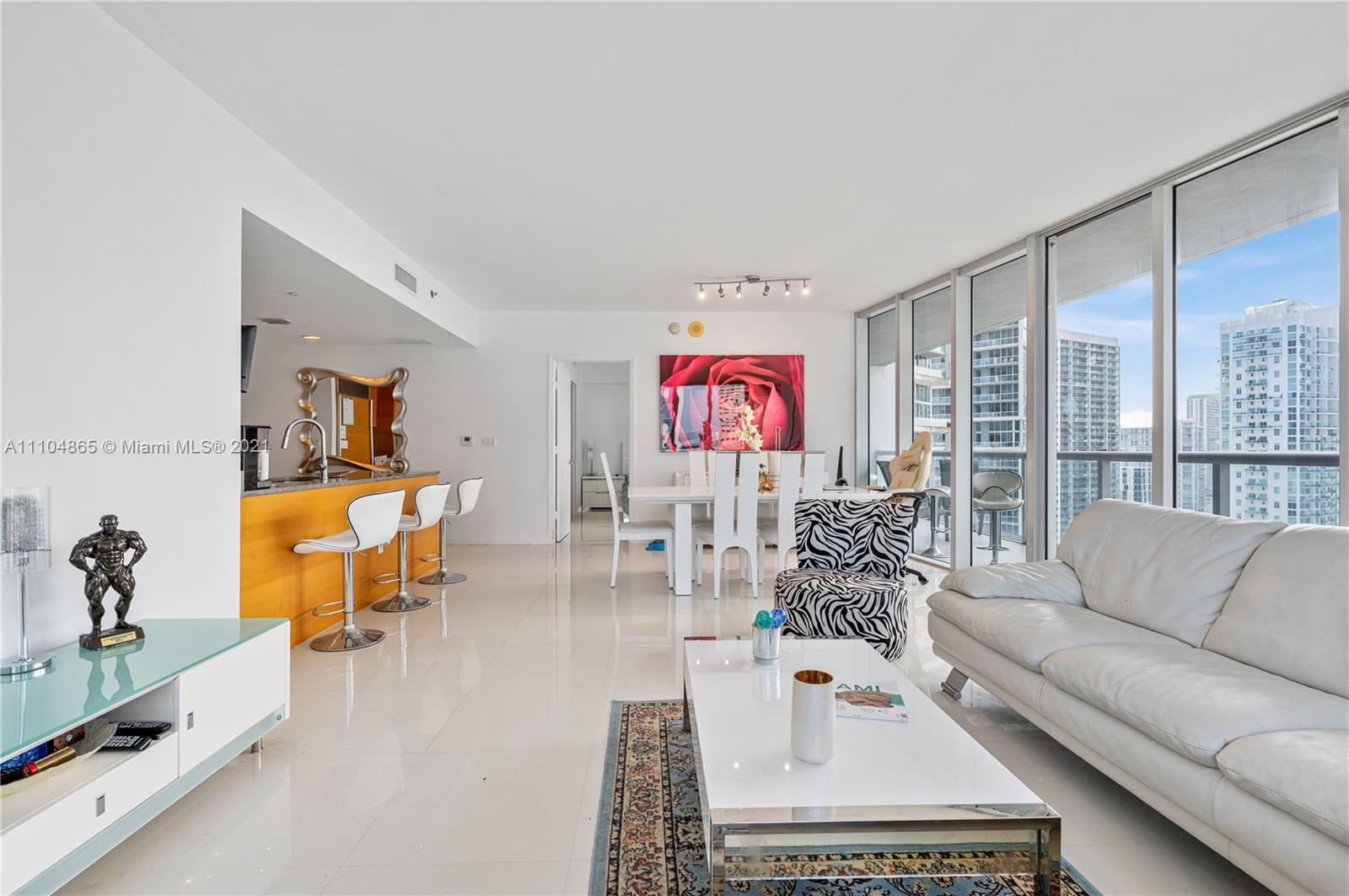 465 Brickell Avenue, Unit 2702 Miami, FL 33131 - Photo 5 of 37 a living room with furniture and a flat screen tv