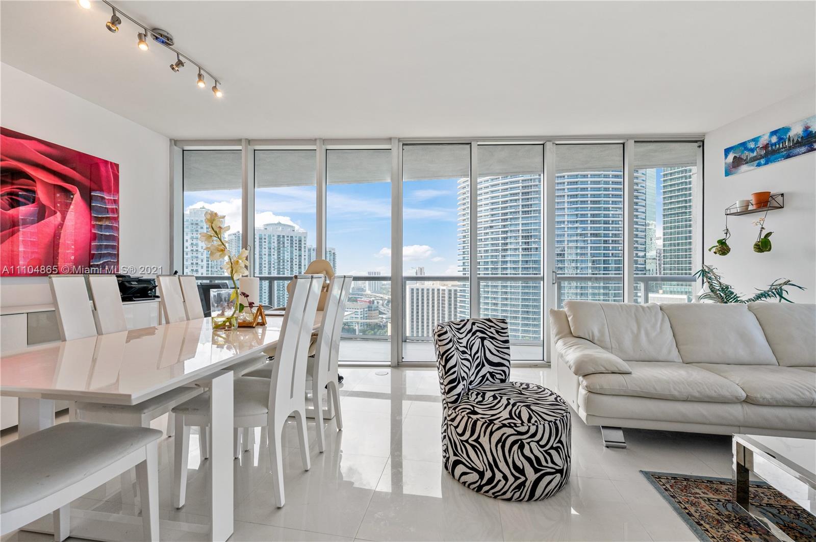 465 Brickell Avenue, Unit 2702 Miami, FL 33131 - Photo 6 of 37 a living room with furniture and a large window