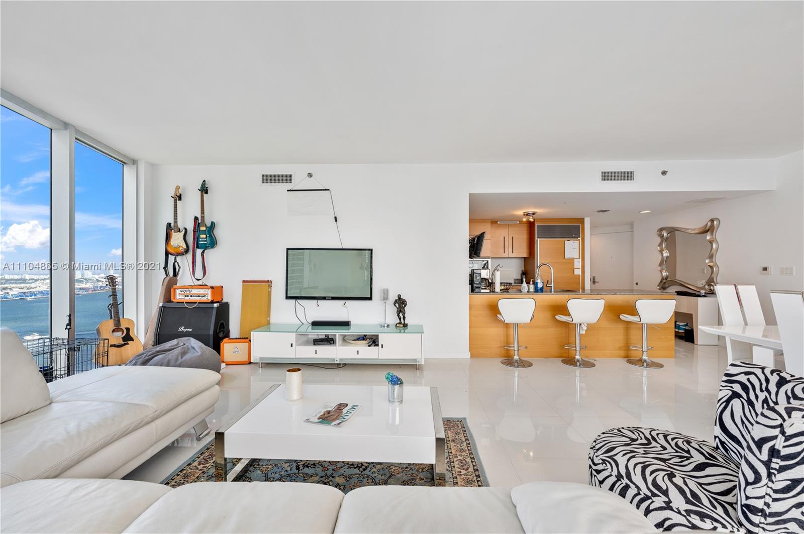 465 Brickell Avenue, Unit 2702 Miami, FL 33131 - Photo 7 of 37 a living room with furniture and a flat screen tv