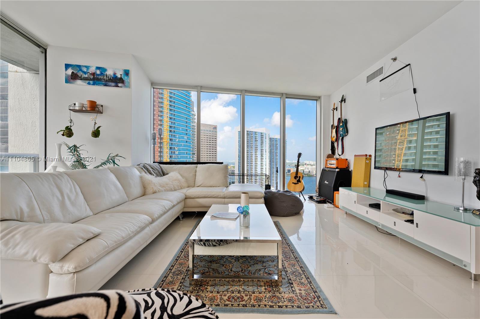 465 Brickell Avenue, Unit 2702 Miami, FL 33131 - Photo 9 of 37 a living room with furniture flat screen tv and a large window
