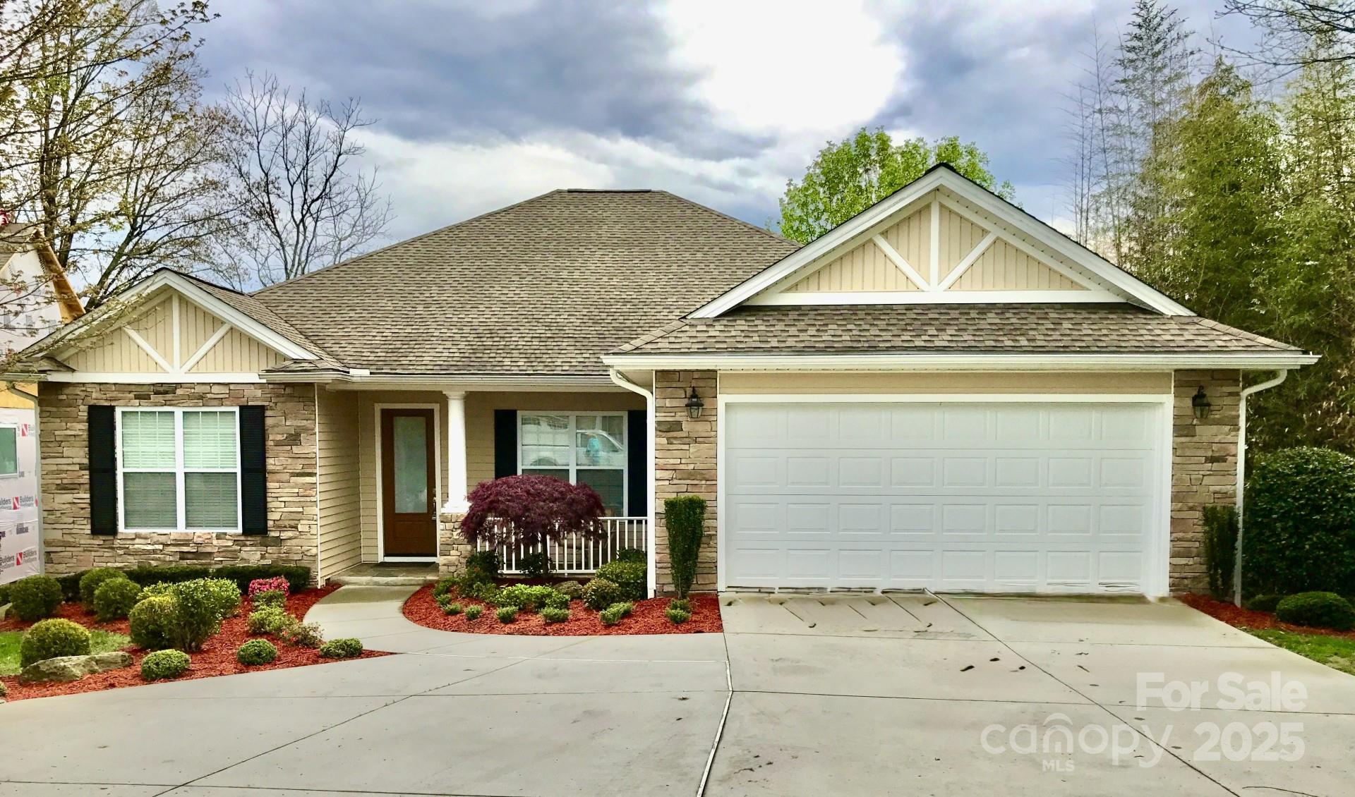 18 Eagle Pointe Way Flat Rock, NC 28731 - Photo 1 of 33 a front view of a house with garden