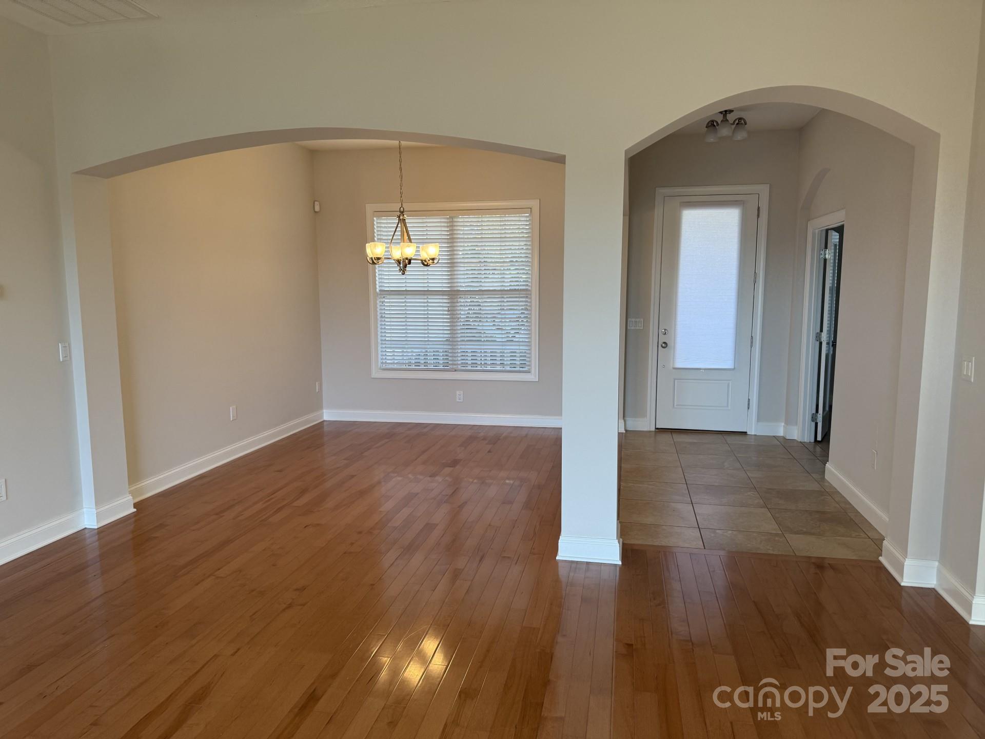 18 Eagle Pointe Way Flat Rock, NC 28731 - Photo 16 of 33 a view of an empty room with wooden floor and a window