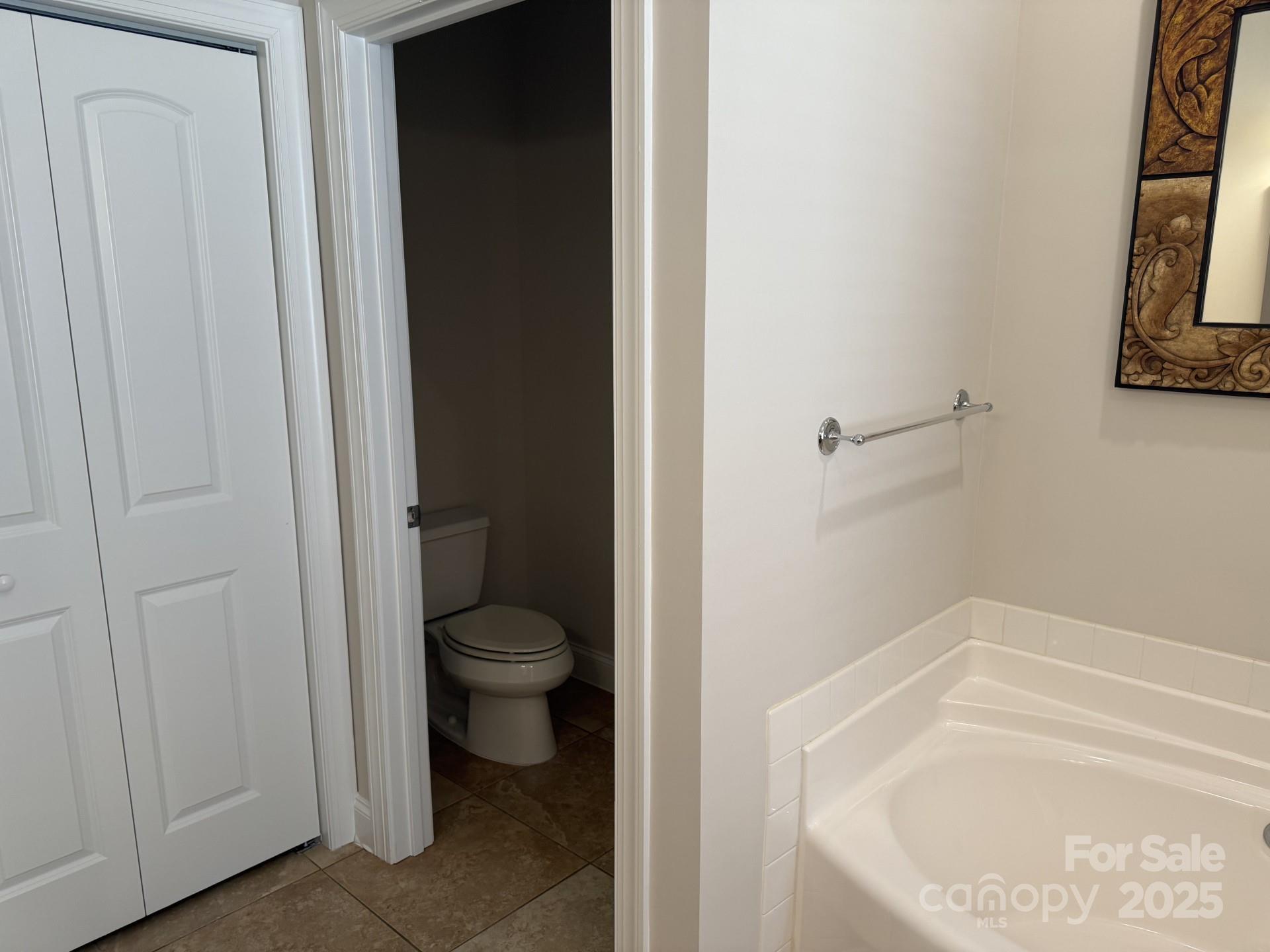 18 Eagle Pointe Way Flat Rock, NC 28731 - Photo 25 of 33 a bathroom with a granite countertop toilet and a bathtub