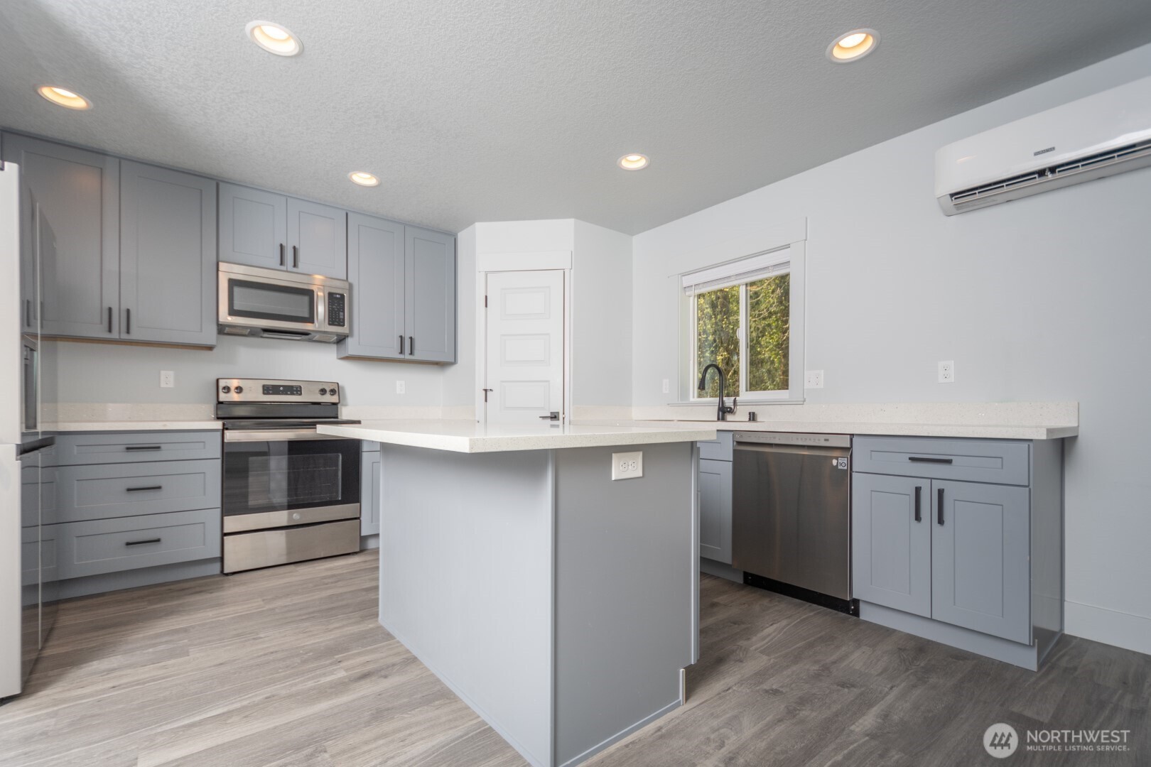 206 Oak Street Winlock, WA 98596 - Photo 5 of 21 a kitchen with granite countertop white cabinets and stainless steel appliances