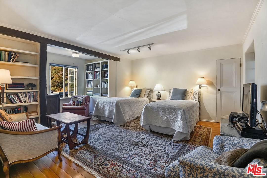 1038 Palisades Beach Road Santa Monica, CA 90403 - Photo 13 of 18 a bedroom with furniture and a flat screen tv