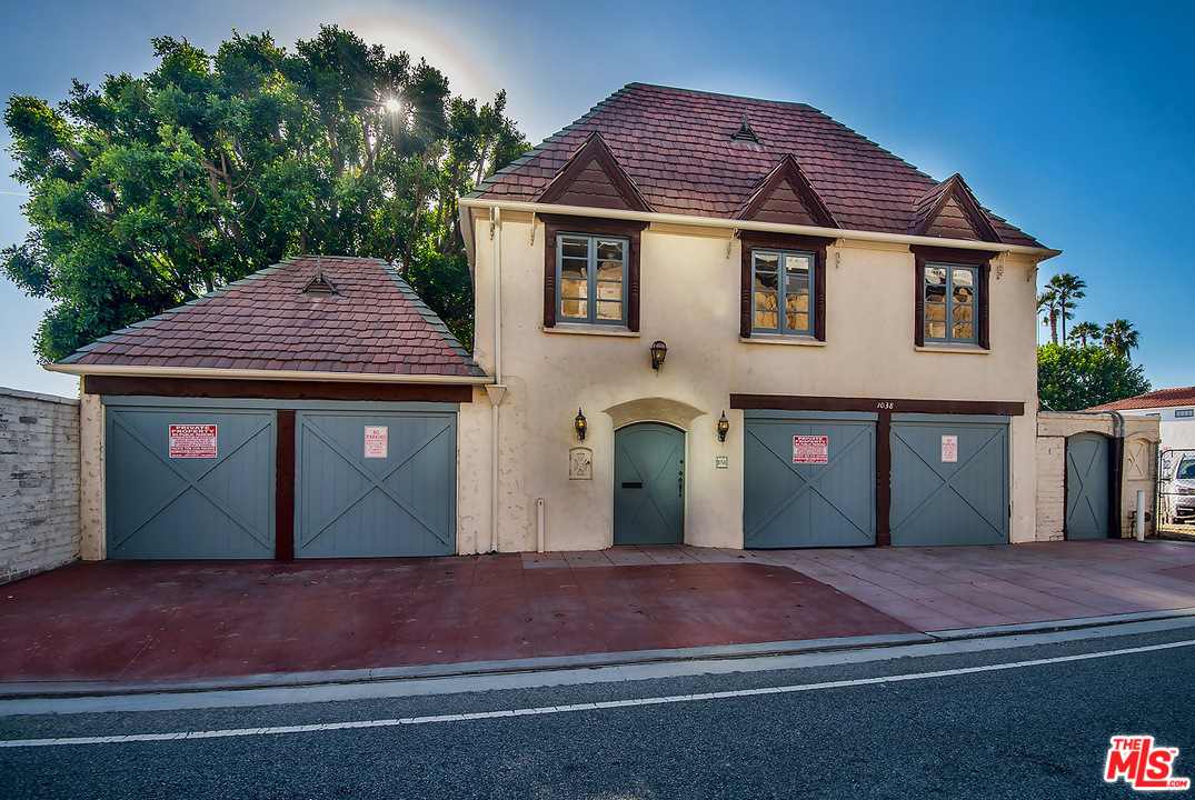 1038 Palisades Beach Road Santa Monica, CA 90403 - Photo 3 of 18 a front view of a house with a yard and garage