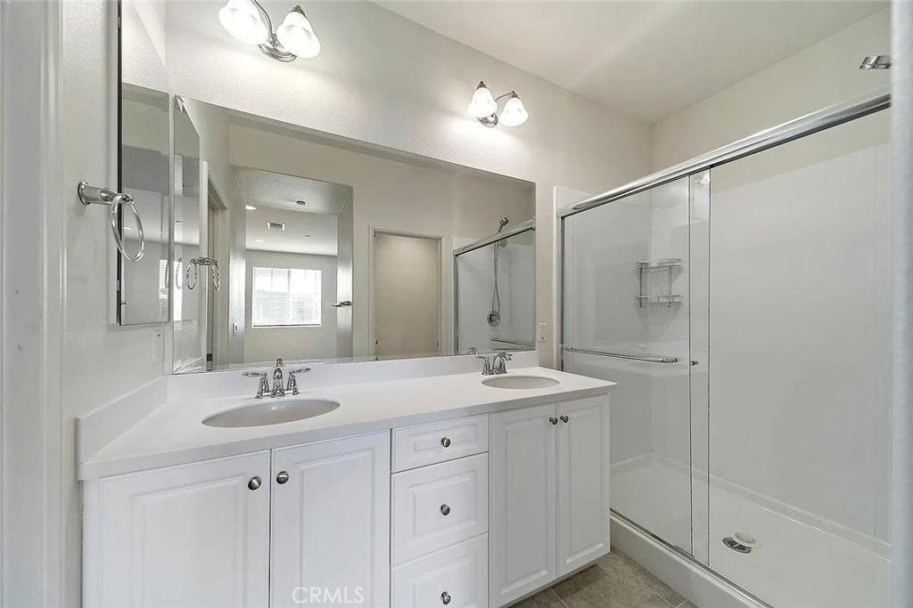 7364 Solstice Place Rancho Cucamonga, CA 91739 - Photo 11 of 19 a bathroom with a double vanity sink mirror and shower