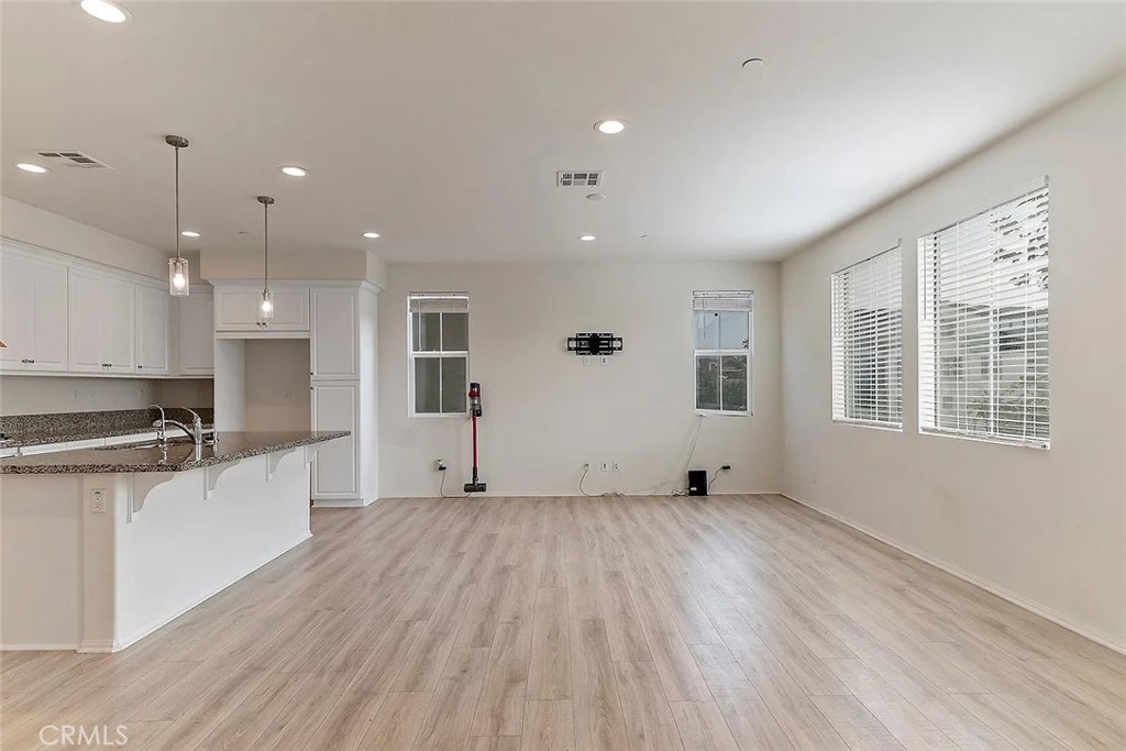 7364 Solstice Place Rancho Cucamonga, CA 91739 - Photo 9 of 19 a view of a kitchen with a sink and wooden floor