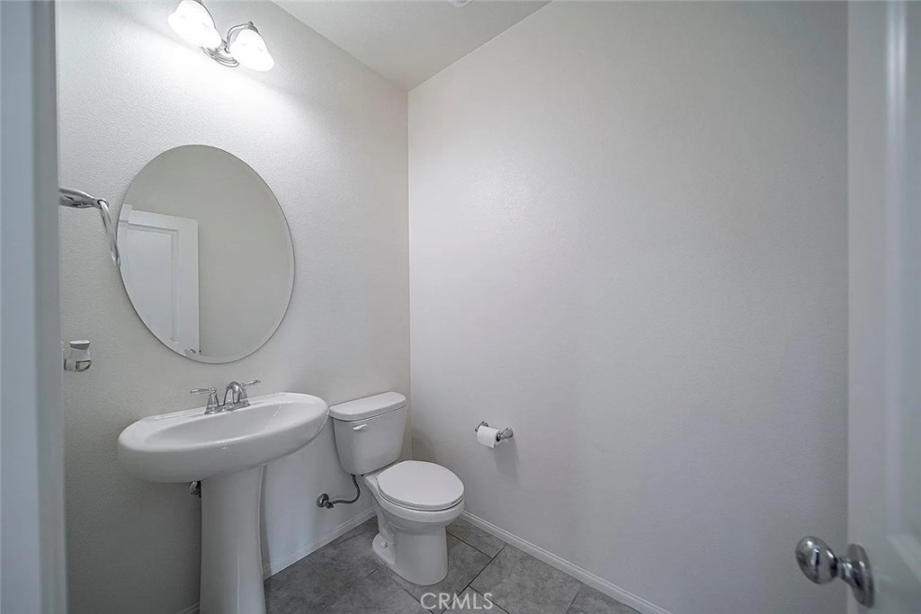 7364 Solstice Place Rancho Cucamonga, CA 91739 - Photo 10 of 19 a bathroom with a toilet a sink and mirror