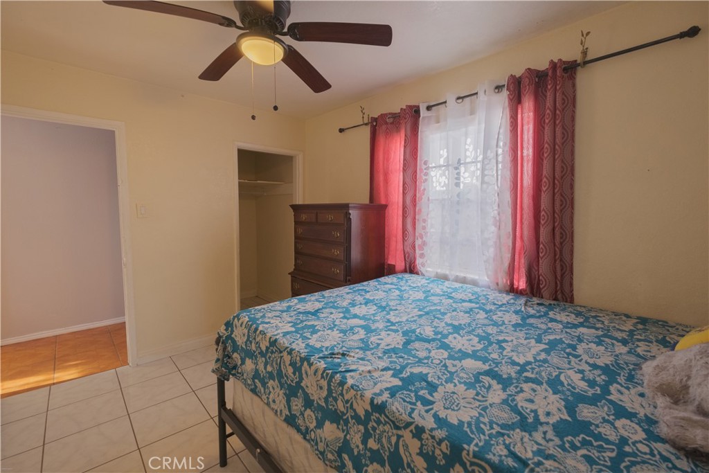 2534 East 127th Street Compton, CA 90222 - Photo 12 of 22 a bedroom with a bed and a chandelier