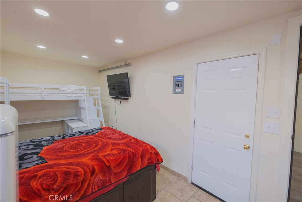 2534 East 127th Street Compton, CA 90222 - Photo 13 of 22 a bedroom with a bed and a flat screen tv