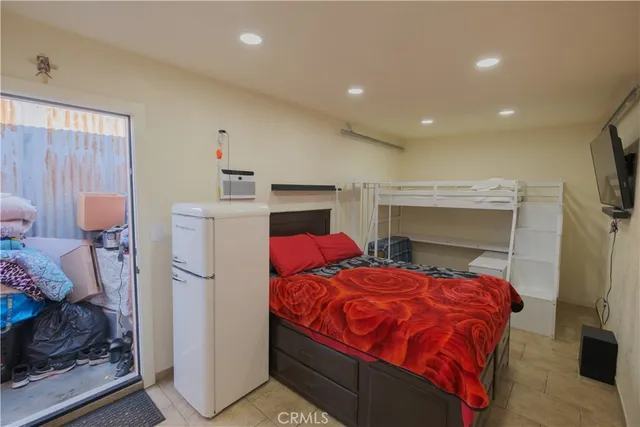 a bedroom with a bed and a tv