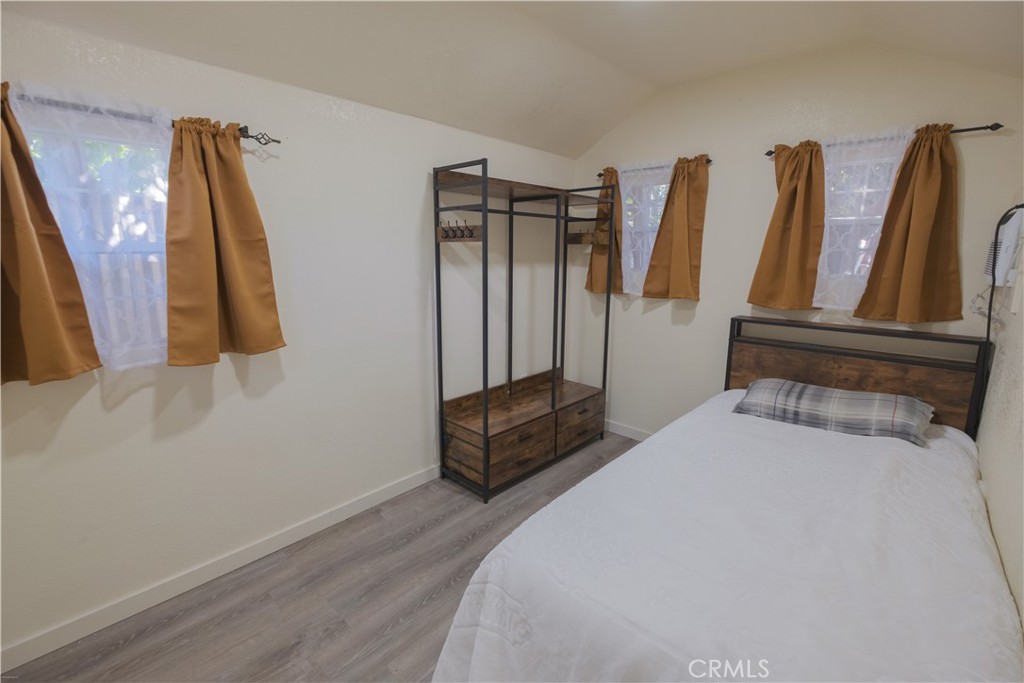 2534 East 127th Street Compton, CA 90222 - Photo 17 of 22 a bedroom with a bed and wooden floor