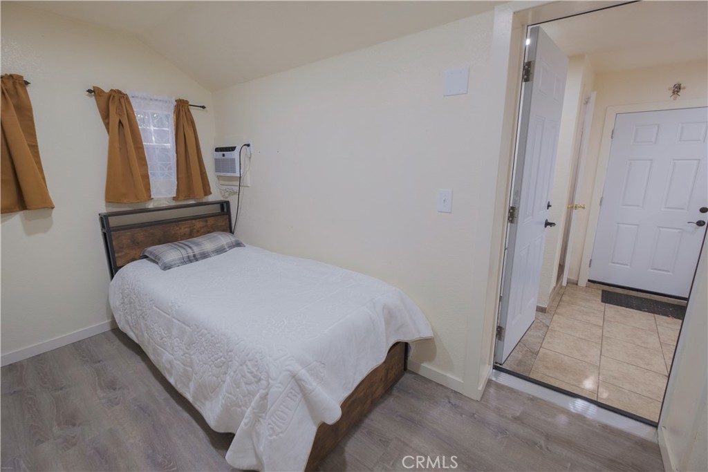 2534 East 127th Street Compton, CA 90222 - Photo 18 of 22 a bedroom with a bed and a painting on the wall