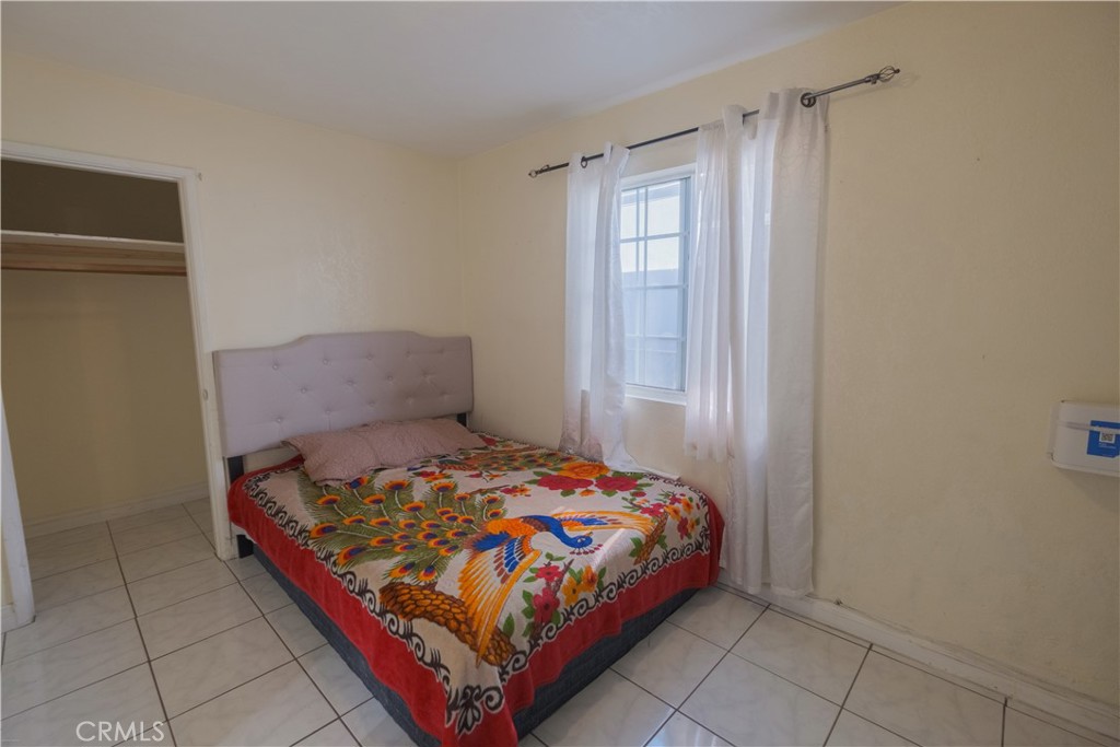 2534 East 127th Street Compton, CA 90222 - Photo 19 of 22 a bedroom with a bed and window