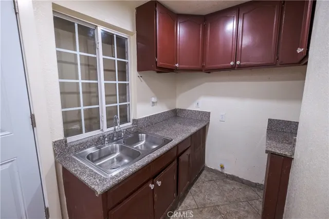 a kitchen with a sink a stove and cabinets