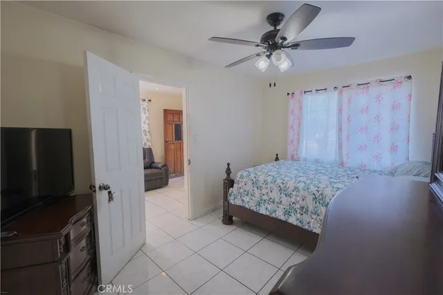 a living room with a bed furniture and a flat screen tv