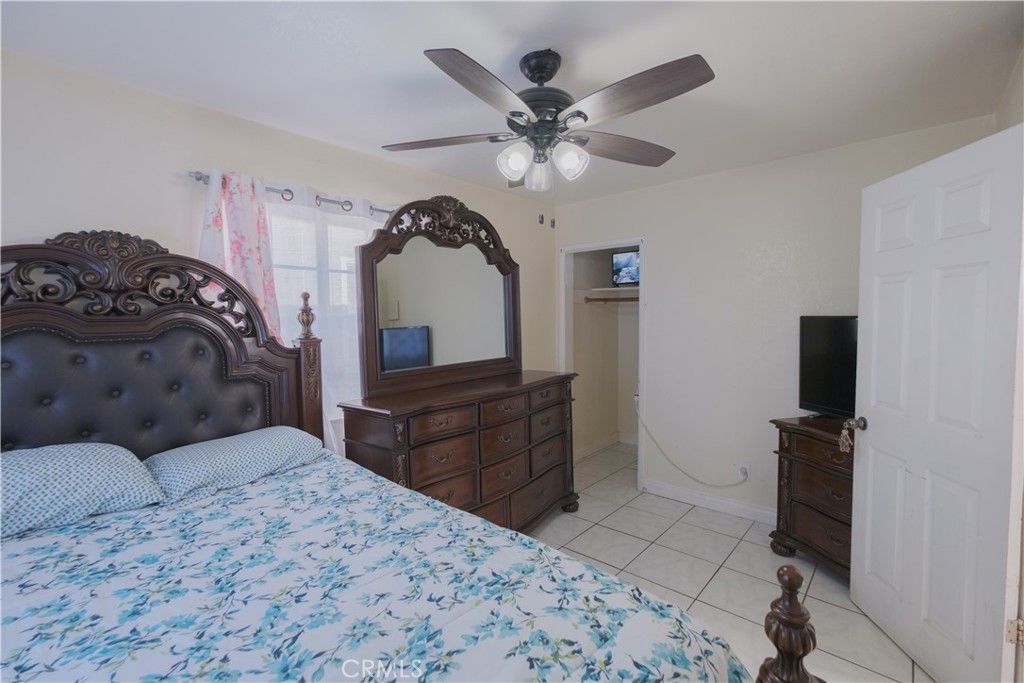 2534 East 127th Street Compton, CA 90222 - Photo 9 of 22 a bedroom with a bed and a flat tv screen on dresser