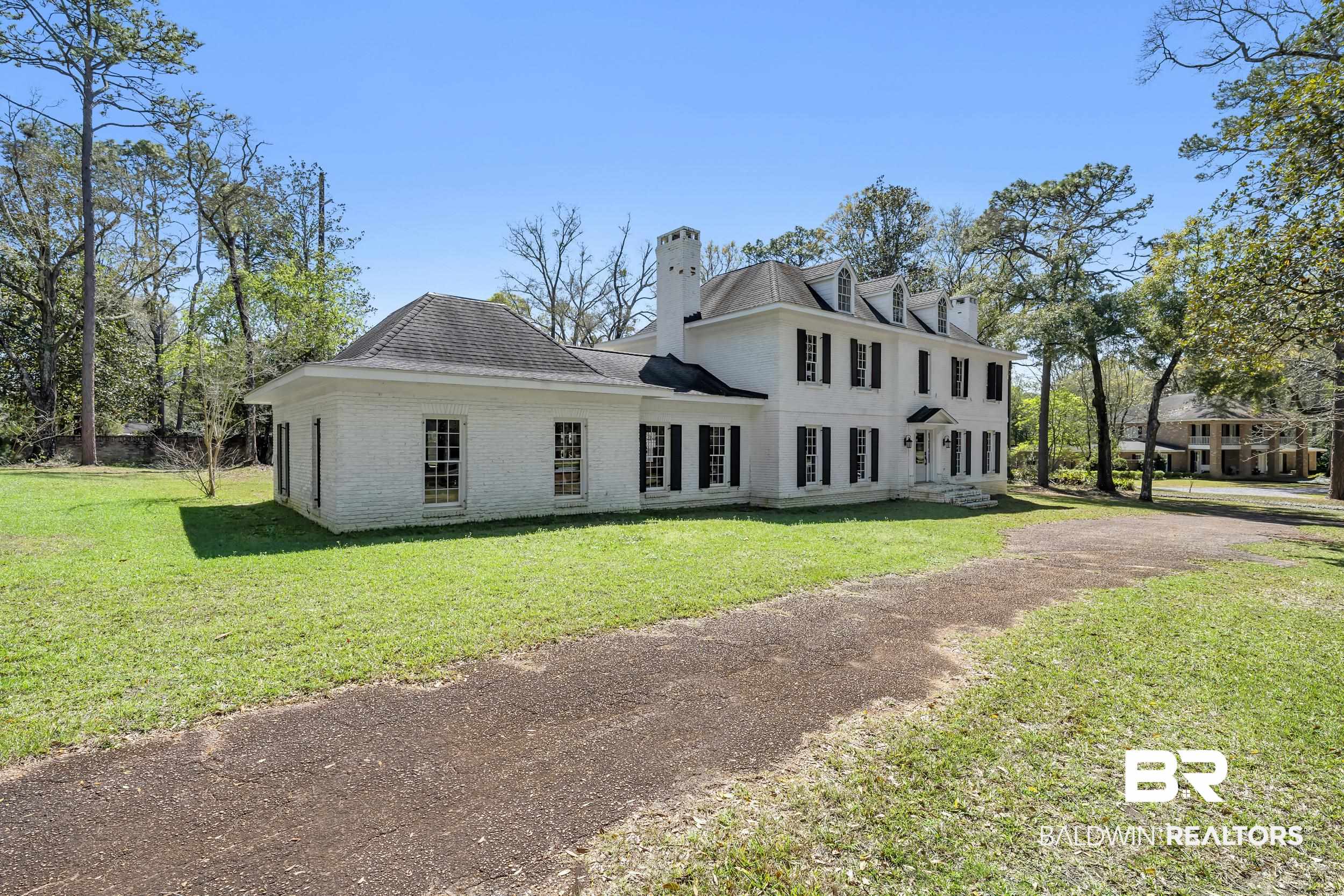 5801 South Fairfax Road Mobile, AL 36608 - Photo 2 of 29 Rear view of house with brick siding, a yard, and a chimney
