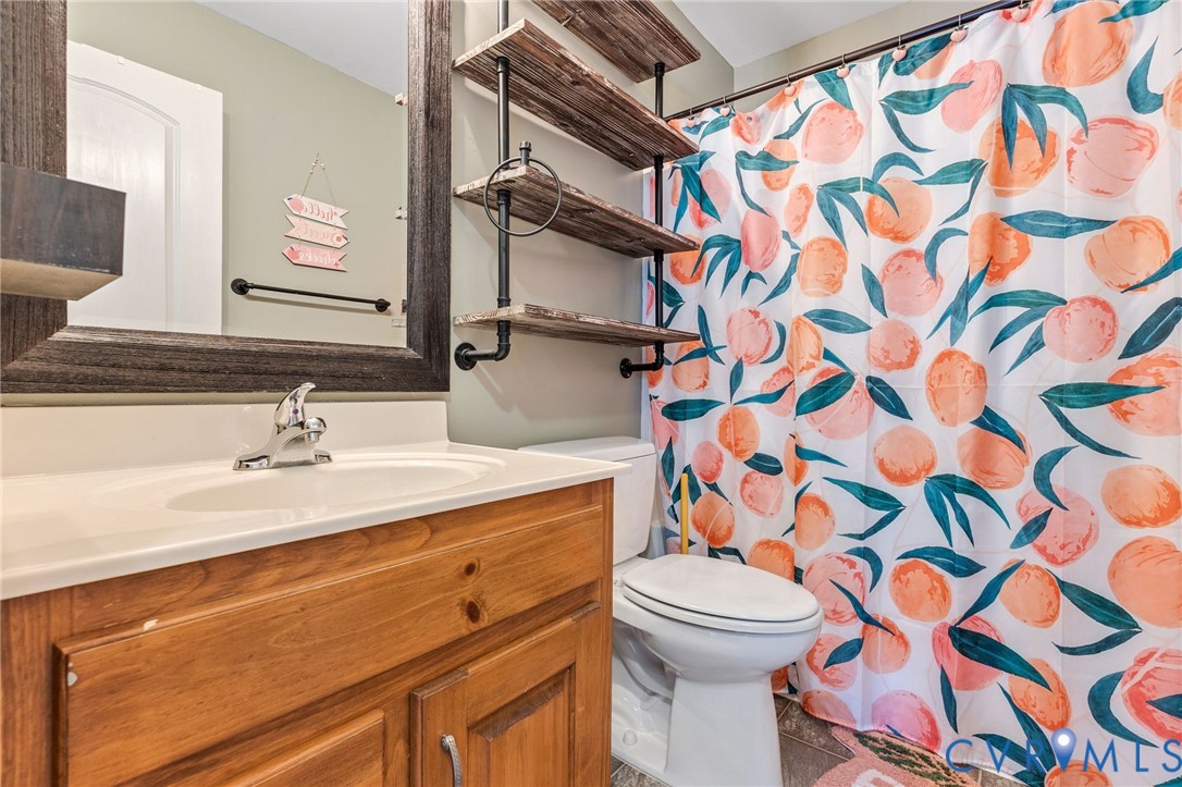 6338 Oak Drive Quinton, VA 23141 - Photo 12 of 25 a bathroom with a sink and a mirror