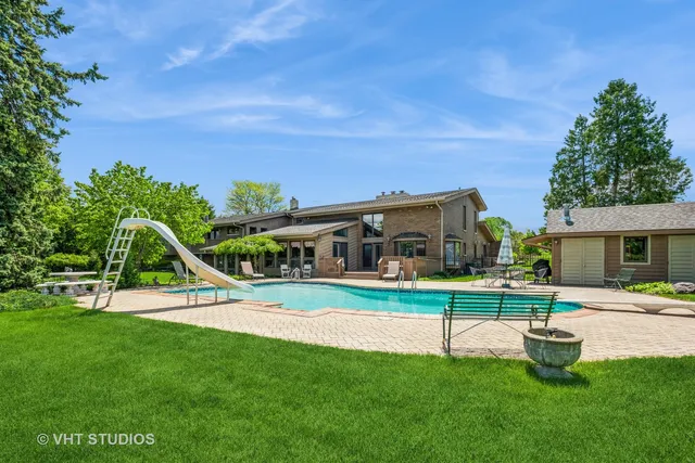 a view of a house with a big yard and a large tree