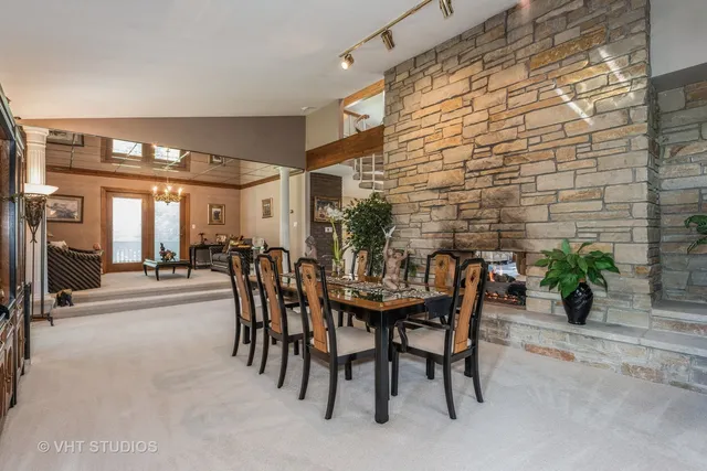 a dining room with furniture and potted plants