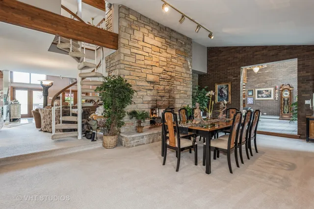 a view of a dining room with furniture and chandelier