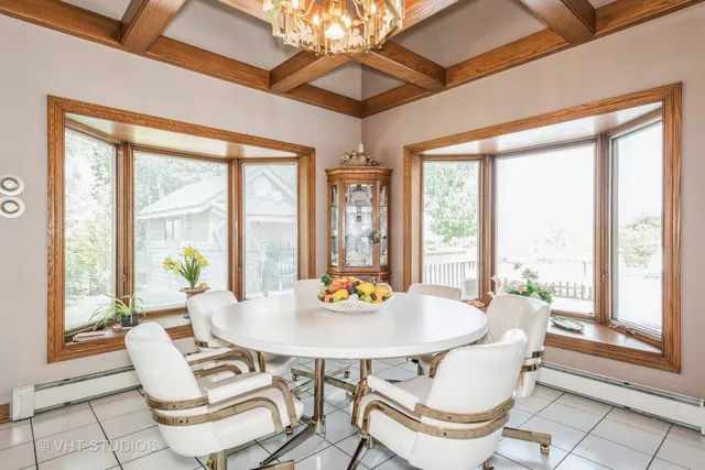 a outdoor dining space with furniture and large windows