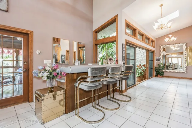 a dining room with furniture and a floor to ceiling window