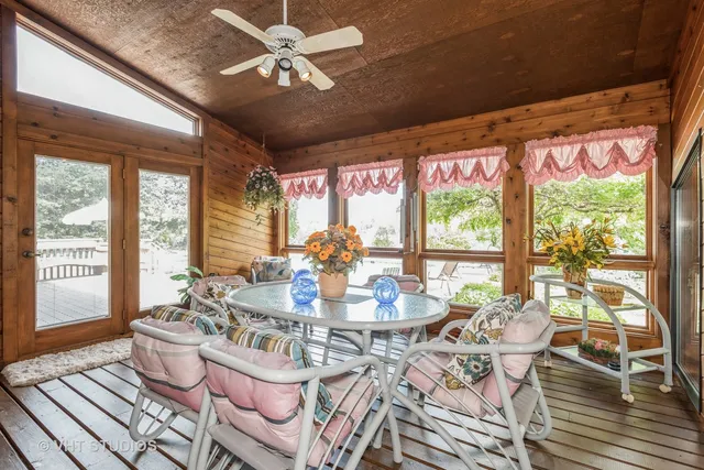 a dining room with furniture a chandelier and wooden floor