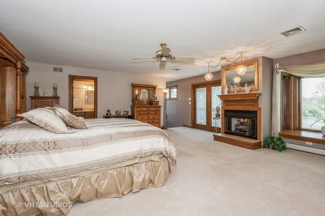 a spacious bedroom with a bed and a fireplace