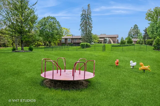 a view of a chair and table sitting in the grass
