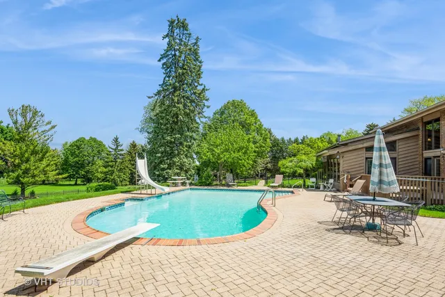 a view of a swimming pool with a outdoor seating