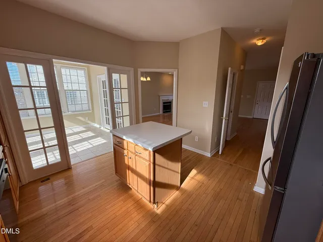 an empty room with windows and ceiling fan