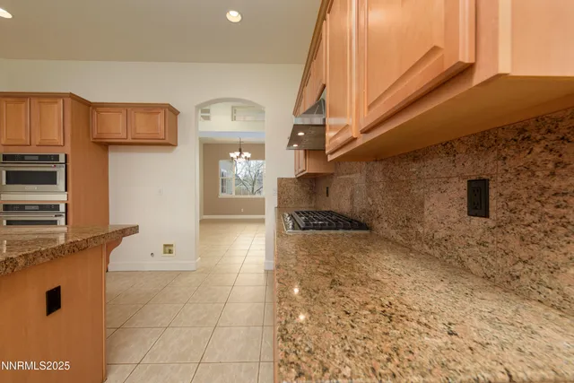 a kitchen with stainless steel appliances granite countertop a stove top oven a sink a counter top space and cabinets