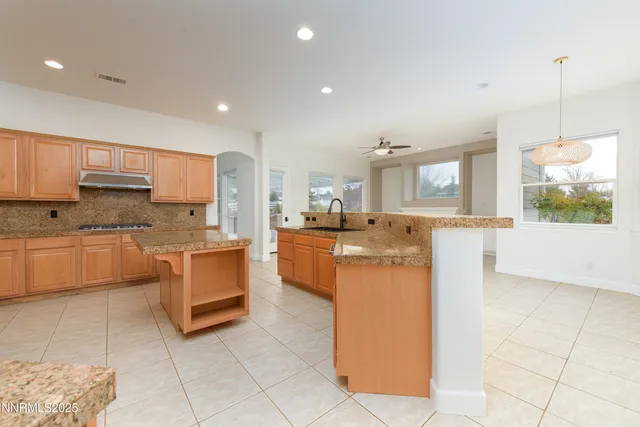a kitchen with granite countertop cabinets and steel stainless steel appliances