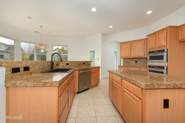 a kitchen with granite countertop white cabinets and sink